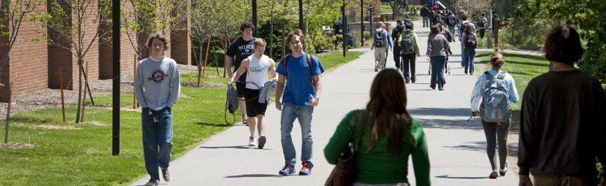 A picture of students walking down the Quarter-mile at RIT on a sunny day